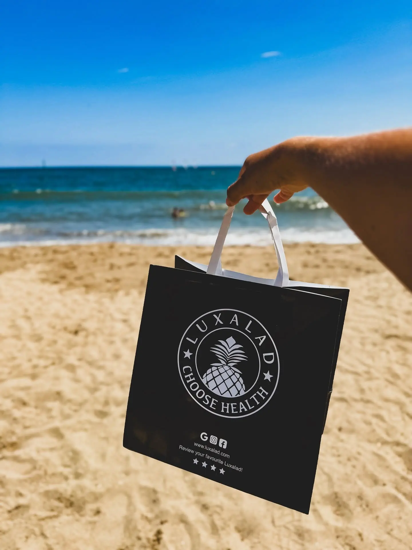 A Luxalad takeaway bag carried down onto the sand