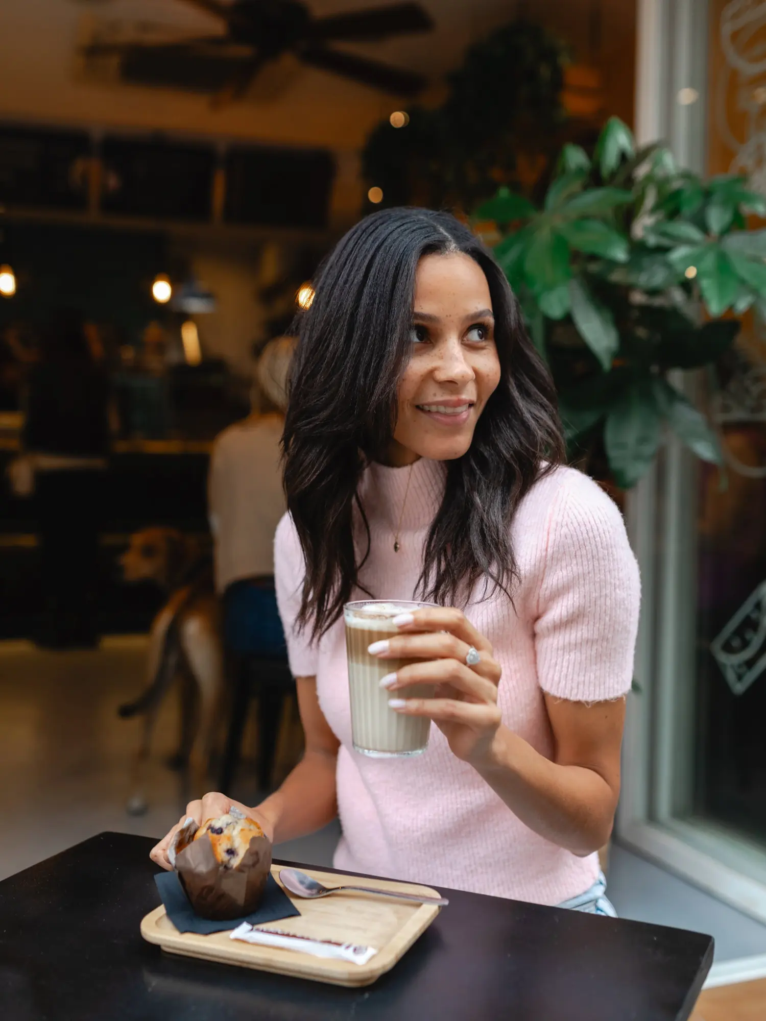 A guest with a coffee at a Luxalad window table
