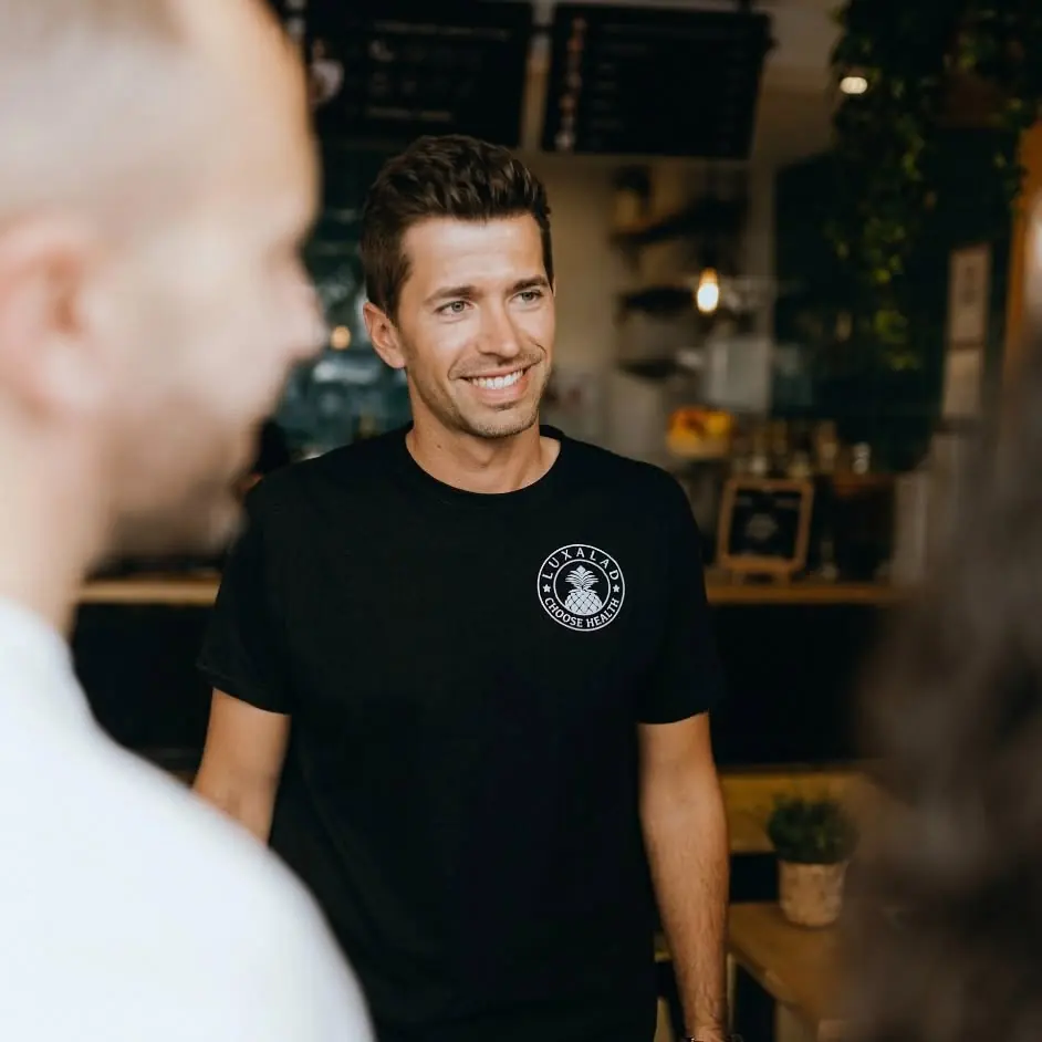A Luxalad team member greeting a guest across the counter