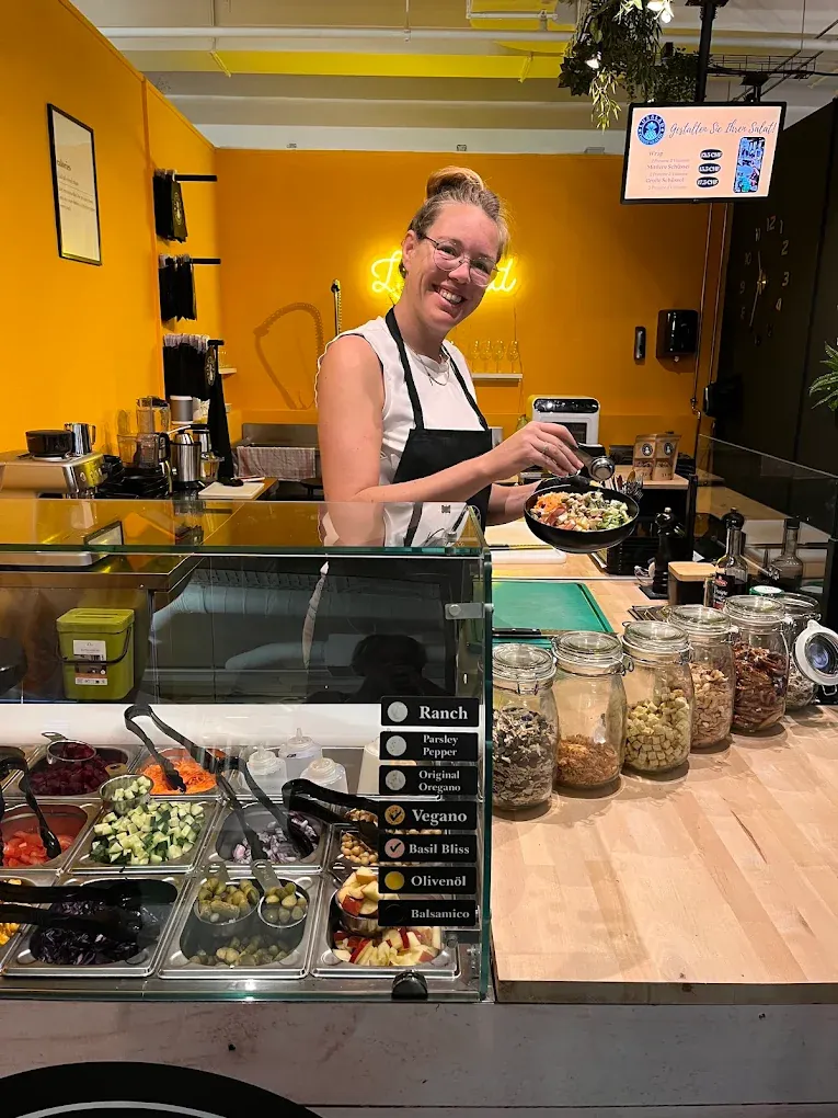 A Luxalad team member preparing a bowl at the Basel salad bar