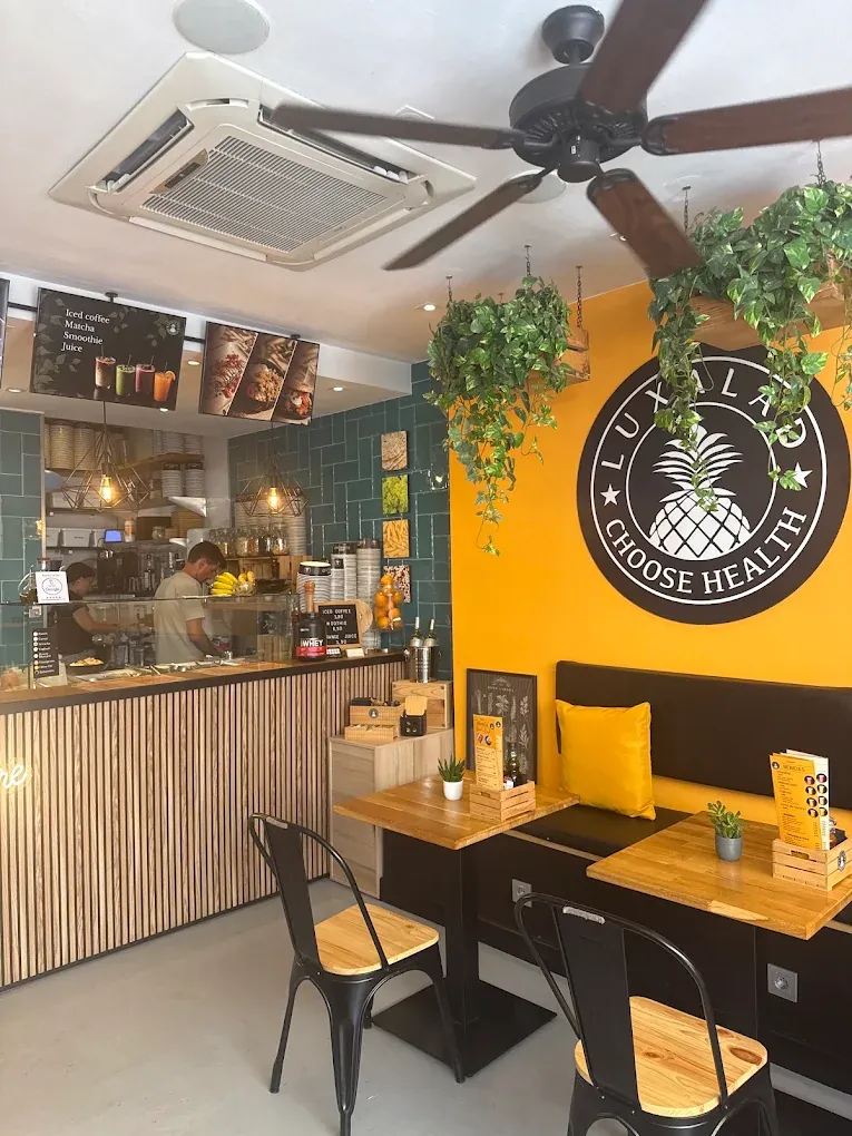 Inside Luxalad Marbella, with the pineapple badge on the wall